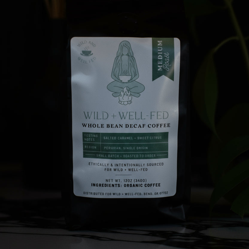 Coffee package labeled 'Wild + Well Fed' on a dark background