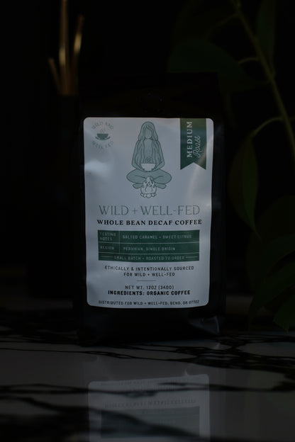 Coffee package labeled 'Wild + Well Fed' on a dark background