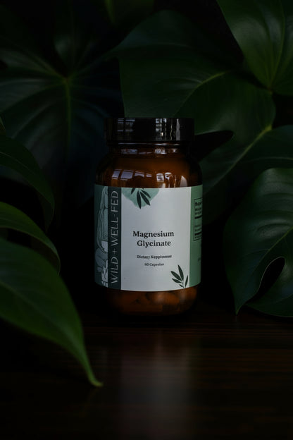 Supplement bottle labeled 'Magnesium Glycinate' with a green leafy background