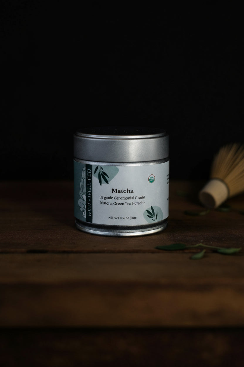 Matcha green tea powder canister on a wooden surface with a dark background